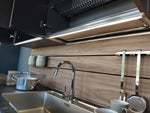 Cucina design con penisola "Kali" By Arredo3 in Noce Imperial e PET INOX